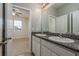 Bathroom featuring double sinks, granite countertops, and light fixtures at 13637 Blythewood Dr, Spring Hill, FL 34609