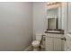 Bathroom with granite countertop vanity, a toilet, and a tiled floor at 13637 Blythewood Dr, Spring Hill, FL 34609