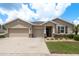 Charming single-story home with a three-car garage, stone accents, and a well-manicured lawn at 13637 Blythewood Dr, Spring Hill, FL 34609