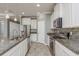 Charming kitchen featuring granite countertops, stainless steel appliances, and ample cabinet space at 13637 Blythewood Dr, Spring Hill, FL 34609