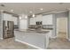 Modern kitchen with stainless steel appliances, granite counters, pendant lighting, and white cabinets at 13637 Blythewood Dr, Spring Hill, FL 34609