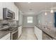 Bright kitchen showcasing granite countertops, stainless steel appliances, and a spacious eat-in area at 13637 Blythewood Dr, Spring Hill, FL 34609