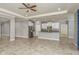 Spacious living room, kitchen island, with stainless steel appliances and lots of natural light at 13637 Blythewood Dr, Spring Hill, FL 34609
