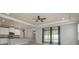 Stylish living area with view to the kitchen and pool beyond glass sliding doors at 13637 Blythewood Dr, Spring Hill, FL 34609