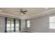 Bright living area with a ceiling fan and sliding glass doors leading to a pool area at 13637 Blythewood Dr, Spring Hill, FL 34609
