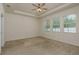 Spacious main bedroom featuring a tray ceiling and multiple windows, creating a bright and airy feel at 13637 Blythewood Dr, Spring Hill, FL 34609