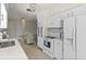 Eat-in kitchen with white cabinets and countertops, flowing into dining area at 13880 Dominica Dr, Seminole, FL 33776