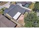 Backyard aerial view of the home, featuring a screened porch, brick patio with a fire pit and an in-ground pool at 1416 Buckner Rd, Valrico, FL 33596