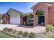 Charming single-story home featuring a brick archway, mature landscaping, and an attached two-car garage at 1416 Buckner Rd, Valrico, FL 33596