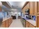 Spacious eat-in kitchen featuring stone countertops, stainless steel appliances, tile flooring and ample cabinetry at 1416 Buckner Rd, Valrico, FL 33596