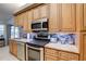 Kitchen featuring stainless steel appliances, tile backsplash, stone countertops, tile flooring, and ample cabinetry at 1416 Buckner Rd, Valrico, FL 33596