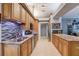 Modern kitchen with stainless steel appliances, beautiful backsplash, granite countertops and spacious cabinetry at 1416 Buckner Rd, Valrico, FL 33596