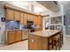 Charming kitchen with light wood cabinetry, granite countertops, stainless steel appliances and breakfast bar seating at 1416 Buckner Rd, Valrico, FL 33596