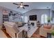 Comfortable living room with fireplace, ceiling fan, hardwood floors, and large windows with wooden shutters at 1416 Buckner Rd, Valrico, FL 33596