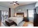 Comfortable main bedroom with a ceiling fan, wood floors, decorative wall hangings, and a sliding glass door at 1416 Buckner Rd, Valrico, FL 33596
