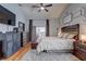 Well-lit main bedroom featuring a ceiling fan, decor, ensuite bathroom, and sliding glass door to outdoor patio at 1416 Buckner Rd, Valrico, FL 33596