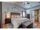 Well-lit main bedroom featuring stylish decor, ceiling fan, and sliding barn door to the ensuite bathroom and walk-in closet at 1416 Buckner Rd, Valrico, FL 33596
