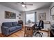 Well-lit home office features hardwood floors, a sofa, and a modern desk at 1416 Buckner Rd, Valrico, FL 33596