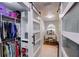 Bright walk-in closet and dressing area featuring frosted sliding doors, wire shelving, and built-in vanity at 1416 Buckner Rd, Valrico, FL 33596