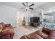 Open-concept living room with hardwood floors, comfortable seating, and a clear view into the kitchen at 14920 Rocky Ledge Dr, Tampa, FL 33625
