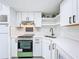 Modern kitchen with white cabinets, stainless steel appliances and white subway tile backsplash at 1600 Pasadena Dr, Dunedin, FL 34698