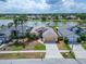 Inviting home features a well-manicured lawn and charming curb appeal, with a serene lake view in the background at 1601 Westerly Dr, Brandon, FL 33511