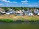 Aerial view of the rear of homes along a river, highlighting the screen enclosed pools and fenced yards at 1601 Westerly Dr, Brandon, FL 33511