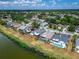 An aerial view of homes in a residential neighborhood with lush green trees and serene water views on a sunny day at 1601 Westerly Dr, Brandon, FL 33511