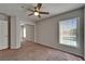 Bedroom offers carpeted floors, a fan, and a window with a view of the pool at 1601 Westerly Dr, Brandon, FL 33511