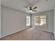 Bright bedroom featuring a ceiling fan and backyard view through large windows at 1601 Westerly Dr, Brandon, FL 33511