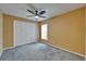 A bedroom with a ceiling fan and a window, complete with built in closet at 1601 Westerly Dr, Brandon, FL 33511