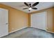 A bedroom with a ceiling fan and closet, complete with neutral colored walls at 1601 Westerly Dr, Brandon, FL 33511