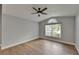 This bedroom has wood-look tile flooring, neutral walls, and bright windows with blinds at 1601 Westerly Dr, Brandon, FL 33511