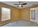 A bedroom with a ceiling fan and one window, complete with carpeted floors at 1601 Westerly Dr, Brandon, FL 33511