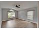 This bedroom features wood-look tile flooring, neutral walls, and bright windows with blinds at 1601 Westerly Dr, Brandon, FL 33511