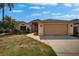 Well-maintained home with lush landscaping, a brick pathway, and a spacious two-car garage at 1601 Westerly Dr, Brandon, FL 33511