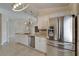 The kitchen features white cabinets, stainless steel appliances, and granite countertops with a stainless refrigerator at 1601 Westerly Dr, Brandon, FL 33511