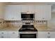 The kitchen shows white cabinets, granite countertops, and stainless steel oven and microwave at 1601 Westerly Dr, Brandon, FL 33511