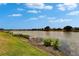 Scenic lake view showcasing the peaceful waters, shoreline vegetation, and nearby houses on the tranquil water's edge at 1601 Westerly Dr, Brandon, FL 33511