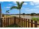 Charming fenced backyard overlooks a serene lake, providing a tranquil setting and a sense of privacy at 1601 Westerly Dr, Brandon, FL 33511