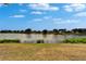 Scenic lake view showcases tranquil waters, lush shoreline vegetation, and distant homes, offering a serene backdrop at 1601 Westerly Dr, Brandon, FL 33511