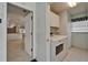 Laundry room with washer, dryer and overhead cabinets with a view to the kitchen at 1601 Westerly Dr, Brandon, FL 33511