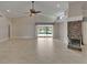 Spacious living room with tile flooring, modern fireplace, and expansive views of the pool area at 1601 Westerly Dr, Brandon, FL 33511