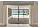 View of the screened patio, pool and backyard lake from inside the home at 1601 Westerly Dr, Brandon, FL 33511