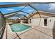 A screened pool provides a serene lake view with a rock waterfall and a spacious deck for relaxation at 1601 Westerly Dr, Brandon, FL 33511