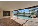 Inviting screened pool with a waterfall feature and scenic lake views, perfect for outdoor enjoyment at 1601 Westerly Dr, Brandon, FL 33511