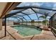 Sparkling screened-in pool with a waterfall feature and serene lake views, an outdoor oasis at 1601 Westerly Dr, Brandon, FL 33511