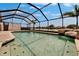 Inviting screened pool with waterfall feature, complemented by a serene lake view backdrop, creating a private oasis at 1601 Westerly Dr, Brandon, FL 33511