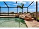 Relaxing screened pool with a rock waterfall feature and lake view, perfect for outdoor enjoyment and relaxation at 1601 Westerly Dr, Brandon, FL 33511