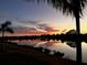 Sunset over water with colorful sky, trees, and a silhouette of palm trees at 1601 Westerly Dr, Brandon, FL 33511